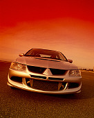 AUT 38 RK0163 04
2003 Mitsubishi Lancer Evolution VIII Silver Vishnu Tuning Head On View On Pavement