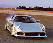 AUT 38 RK0236 01
2003 GSR Noble M12 GTO Silver 3/4 Front View On Pavement Trees Background Filtered
