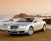 AUT 39 RK0096 03
2004 Bentley Continental GT Silver 3/4 View On Sand By Ocean And Rocks Filtered