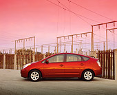 AUT 39 RK0181 01
2004 Toyota Prius Red Side View On Pavement By Electric Wires Filtered
