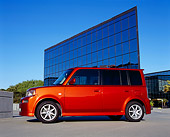 AUT 39 RK0199 02
2004 Toyota Scion XB Orange Low 3/4 Side View On Pavement By Glass Building