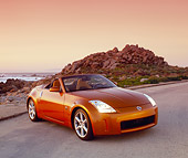 AUT 39 RK0217 03
2004 Nissan 350Z Roadster Orange Sunset Front 3/4 View On Pavement By Coast