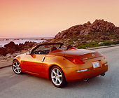AUT 39 RK0218 04
2004 Nissan 350Z Roadster Orange 3/4 Rear View On Pavement By Coast