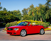 AUT 39 RK0244 02
2004 Audi TT Roadster quattro Red 3/4 Front View On Pavement By Flowers And Trees