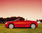 AUT 39 RK0255 02
2004 Audi TT Roadster quattro Red Profile View On Grass Trees Filtered