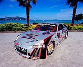 AUT 39 RK0269 02
2004 Nissan 350Z GT3 Race Car 3/4 Front View By Water And Palm Trees