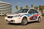 AUT 39 RK0342 01
2004 Ford, Focus, Hydrogen Fuel Cell Electric Car 3/4 Front View On Pavement By Building