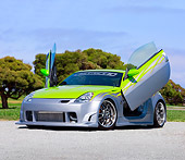 AUT 39 RK0372 01
2004 Nissan 350Z Green And Silver 3/4 Front View By Trees Blue Sky