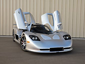 AUT 39 RK0401 01
2004 Mosler MT900S Silver Doors Open 3/4 Front View On Pavement