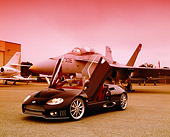AUT 40 RK0061 03
2005 Spyker C8 Spyder Black 3/4 Front View Doors Open On Pavement By Fighter Jet