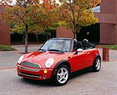 AUT 40 RK0074 01
2005 Mini Cooper Convertible Orange 3/4 Front View On Pavement By Building And Trees