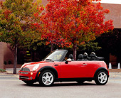 AUT 40 RK0075 02
2005 Mini Cooper Convertible Orange 3/4 Side View On Pavement By Fall Trees And Buildings