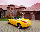 AUT 40 RK0104 02
2005 Nissan 350Z Roadster Yellow 3/4 Rear View On Driveway By House Filtered