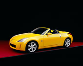 AUT 40 RK0106 07
2005 Nissan 350Z Roadster Yellow 3/4 Side View On Red Floor Studio