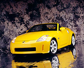 AUT 40 RK0112 02
2005 Nissan 350Z Roadster Yellow 3/4 Front View On Mylar Floor Gray Marble Background Studio