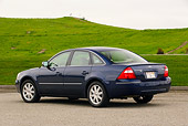 AUT 40 RK0124 01
2005 Ford Five Hundred Sedan Blue 3/4 Rear View On Pavement By Grass Hills