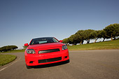 AUT 40 RK0162 01
2005 Scion TC Red Low Head On Shot On Pavement By Grass And Trees
