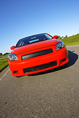 AUT 40 RK0163 01
2005 Scion TC Red Low Head On Shot On Pavement By Grass