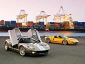 AUT 41 RK0596 01
2006 Ford GTB Gray And Silver 3/4 Front 2006 GTX1 Yellow And Silver 3/4 Side View On Pavement By Shipping Dock