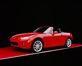 AUT 41 RK0039 08
2006 Mazda, MX-5, Miata, Convertible Red 3/4 Side View On Red Floor Studio