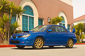 AUT 41 RK0121 01
2006 Subaru Impreza WRX Sti Blue Low 3/4 Side View On Pavement By Building