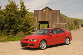 AUT 41 RK0141 01
2006 Mazdaspeed6 Red 3/4 Side View On Pavement By Barn And Trees