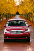 AUT 41 RK0194 01
2006 Infiniti M45 Red Head On Shot On Road By Rows Of Trees