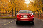 AUT 41 RK0197 01
2006 Infiniti M45 Red Rear View On Pavement On Road By Row Of Trees