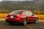 AUT 41 RK0229 01
2006 Infiniti M45 Red 3/4 Rear View On Pavement Hills And Trees Background