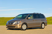 AUT 41 RK0255 01
2006 Honda Odyssey Touring Desert Rock Mist 3/4 Front View On Pavement By Grass Hills