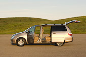 AUT 41 RK0258 01
2006 Honda Odyssey Touring Desert Rock Mist Profile View On Pavement By Grass  Hills Doors Open