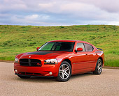 AUT 41 RK0347 02
2006 Dodge Daytona R/T Charger Orange 3/4 Front View On Pavement By Grass Hills