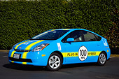 AUT 41 RK0551 01
2006 Toyota Prius Plug-In Hybrid Blue With Yellow Stripes 3/4 Front View On Pavement By Shrubs