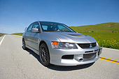 AUT 42 RK0013 01
2007 Mitsubishi Lancer Evolution Silver 3/4 Front View On Road By Grass Hills