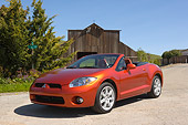AUT 42 RK0014 01
2007 Mitsubishi Eclipse Spyder Orange 3/4 Front View On Pavement By Barn