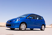 AUT 42 RK0068 01
2007 Honda FIT 5DR Sport Blue Low 3/4 Side View On Pavement By Building