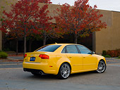AUT 42 RK0111 01
2007 Audi RS4 Yellow 3/4 Rear View On Pavement By Building And Fall Trees