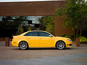 AUT 42 RK0115 01
2007 Audi RS4 Yellow Low Profile View On Pavement By Building