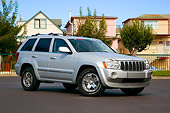 AUT 42 RK0267 01
2007 Jeep Grand Cherokee Overland Silver 3/4 Front View On Pavement By Houses Trees Blue Sky