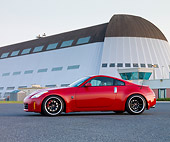 AUT 42 RK0276 01
2007 Nissan 350Z Red 3/4 Front View On Pavement By Hangar