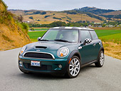 AUT 43 BK0016 01
2007 Mini Cooper S Green And Checkered 3/4 Front View On Road By Grassy Hills