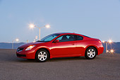 AUT 43 RK0062 01
2008 Nissan Altima 2-door Coupe Red Front 3/4 View On Pavement Street Lights