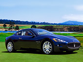 AUT 43 RK0078 01
2008 Maserati GranTurismo Black 3/4 Front View On Grass By Trees Blue Sky