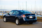 AUT 43 RK0084 01
2008 Nissan Altima Hybrid Dark Blue 3/4 Rear View On Pavement By Marina Sky