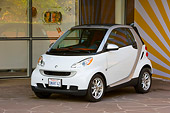 AUT 43 RK0109 01
2008 Smart Fortwo White 3/4 Front View On Pavement By Building