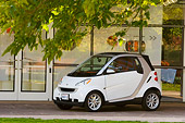 AUT 43 RK0110 01
2008 Smart Fortwo White 3/4 Front View On Pavement By Building