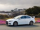 AUT 43 RK0308 01
2008 Mitsubishi Lancer Evolution GSR White 3/4 Front View By Trees Water
