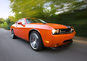 AUT 43 RK0372 01
2008 Dodge Challenger SRT8 Orange 3/4 Front View On Road By Trees