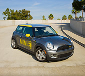 AUT 43 RK0382 01
2008 Mini E Gray And Yellow 3/4 Front View On Pavement By Trees