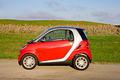 AUT 44 RK0085 01
2009 Smart Fortwo Passion Coupe Red And Silver Profile View On Pavement By Field